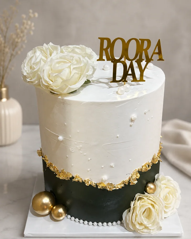 A Roora Day cake in white and deep green with gold leaf and a gold Roora Day topper, by The Cake Studio Harare